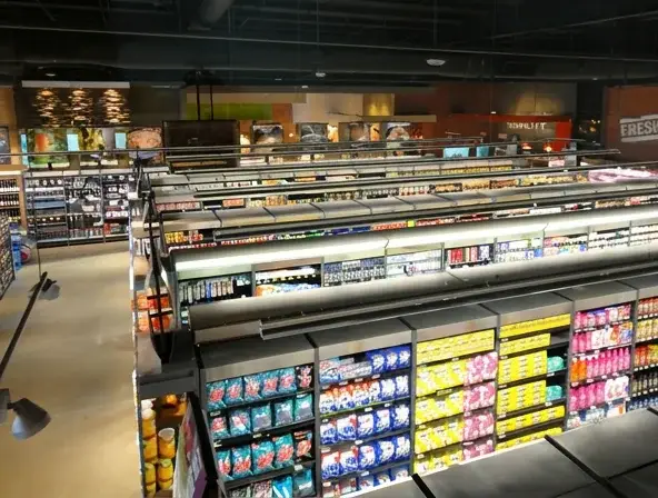 Large supermarket interior featuring custom retail shelving, refrigerated display units and grocery merchandising systems